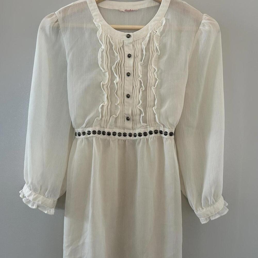 White blouse with black buttons and ruffles